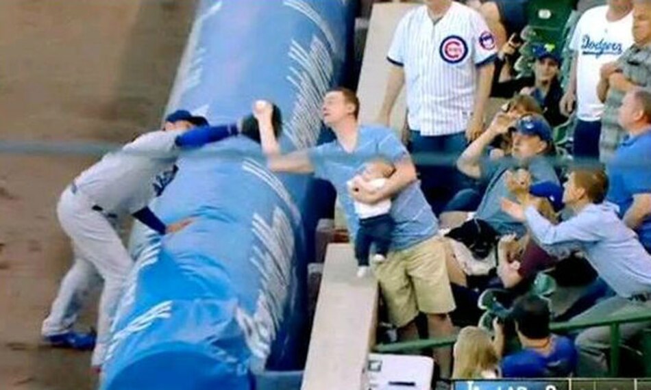 Fanático realiza polémica atrapada, cargando a bebé